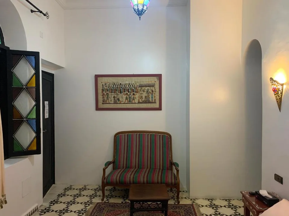 Guest room sitting area with Moroccan furnishings at Riad Tingis